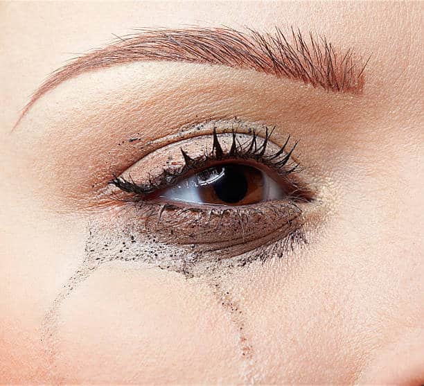 close-up portrait of beautiful crying girl with smeared mascara